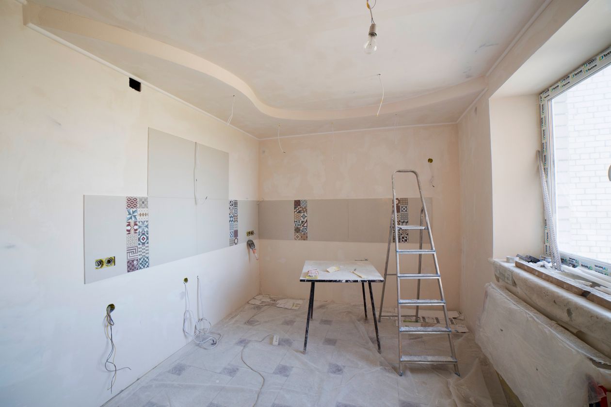Spacious kitchen under renovation with ladder and tools — budget kitchen reno in progress